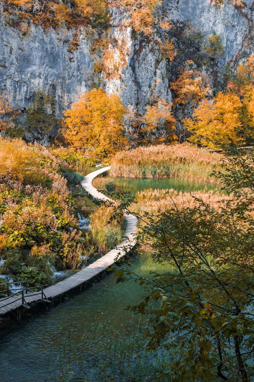 Wooden pathway across lake at Plitvice lakes national park in Croatia in autumn