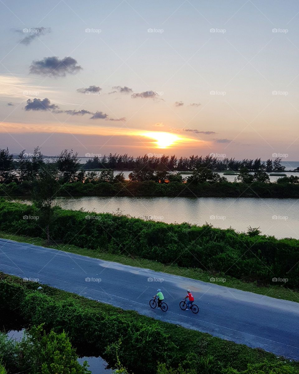 Cycling at the seaside while sunset