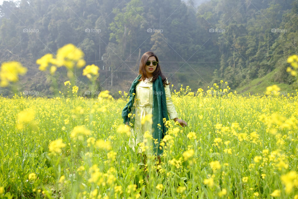 Young woman standing in flowers field