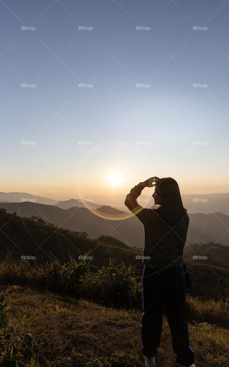 A tourist on Pha Tung Hill during Sunset in Chiangrai Thailand