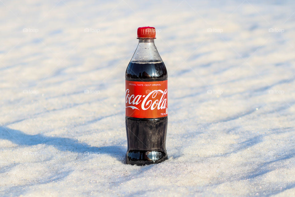 Bottle of a Coca-Cola in a snow