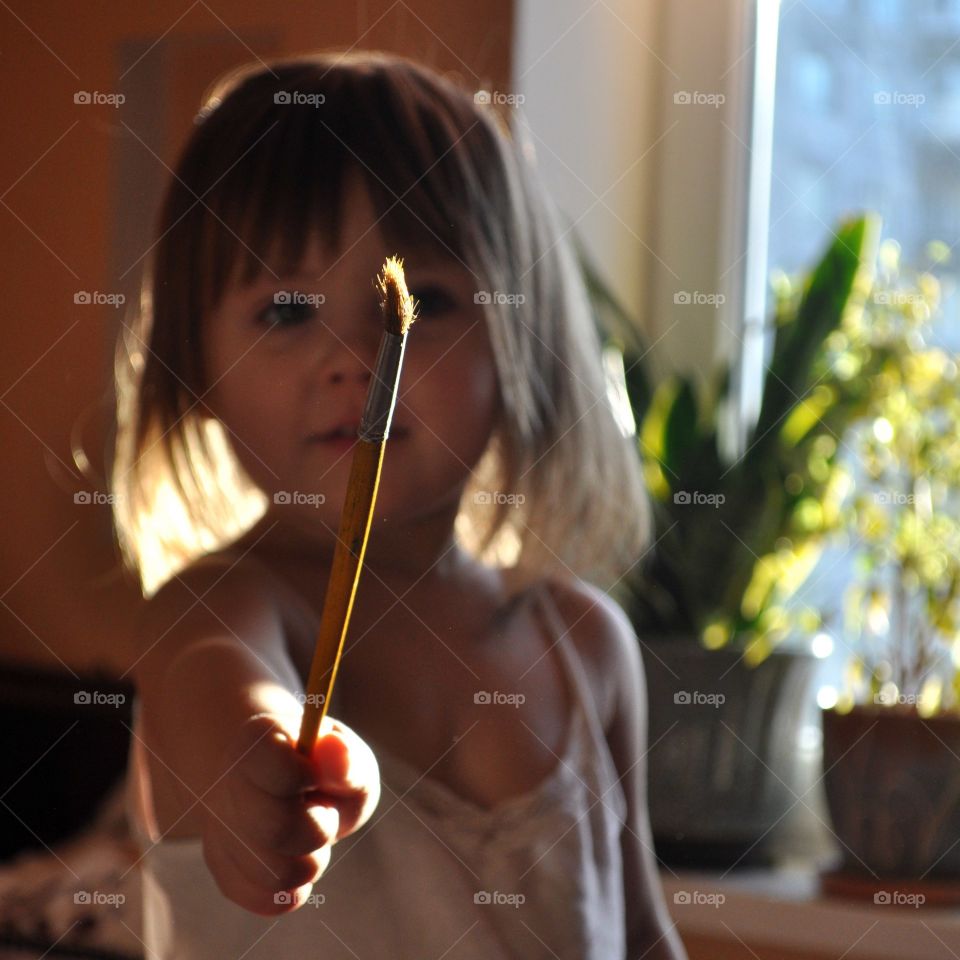 cute little girl with a paint brush