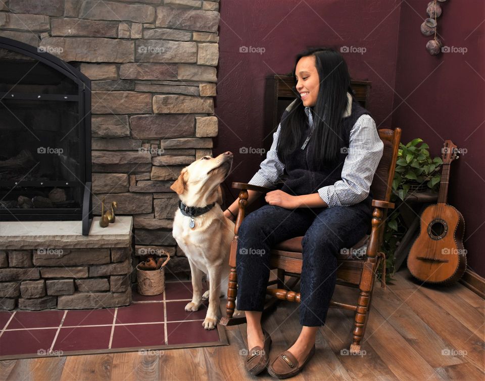 Winter with Friends, girl sitting by a fireplace with a yellow lab