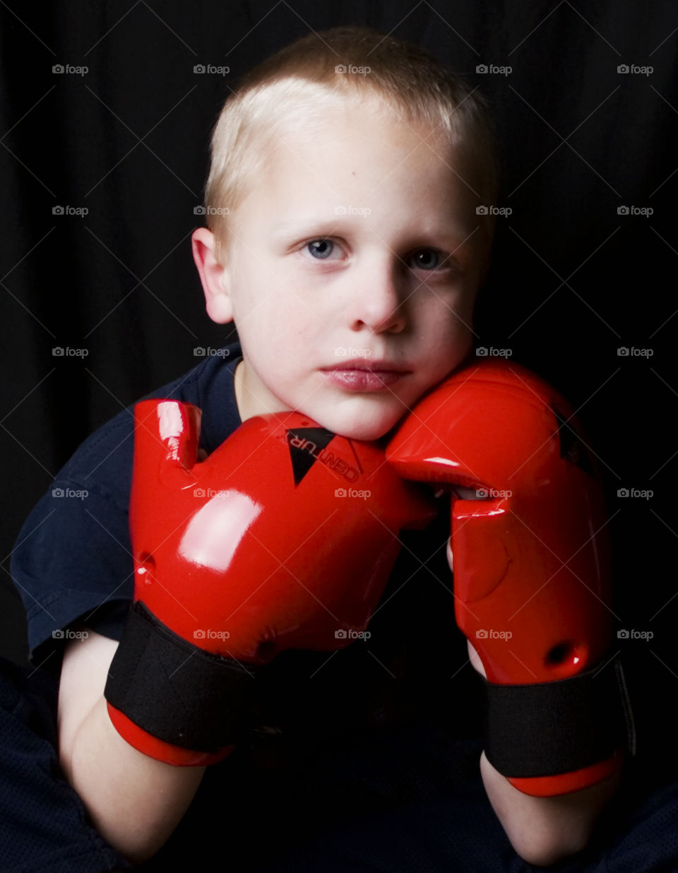 Sparring Partner. A child puts on sparring gear