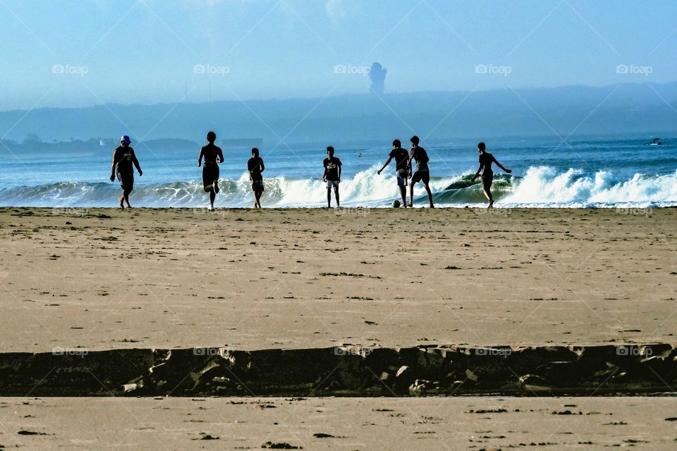 Playing football at the beach