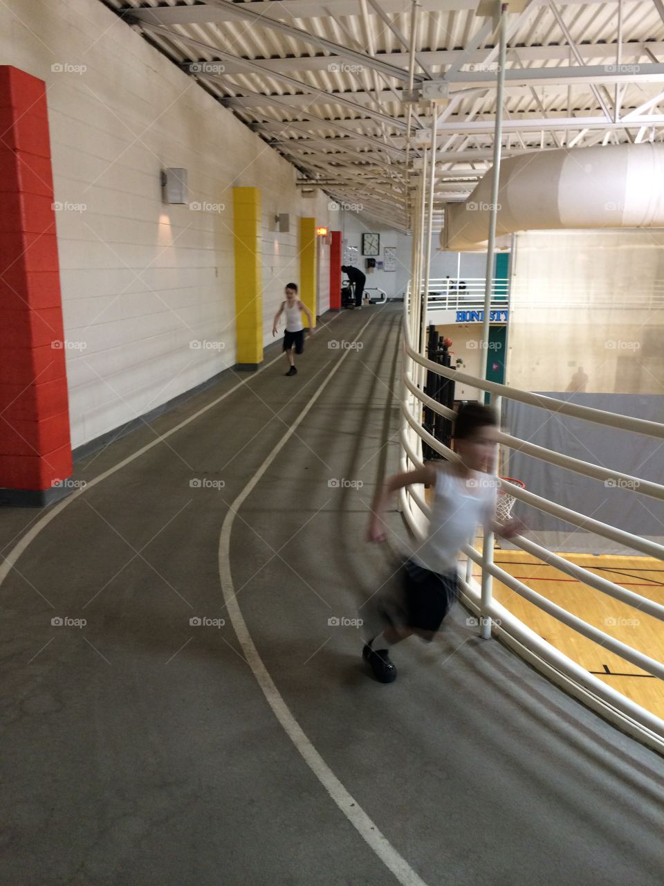 Child running indoor gym track 