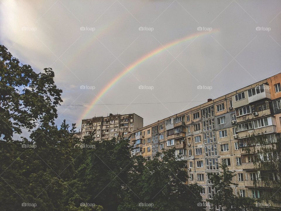 rainbow over the houses in the city of Kyiv