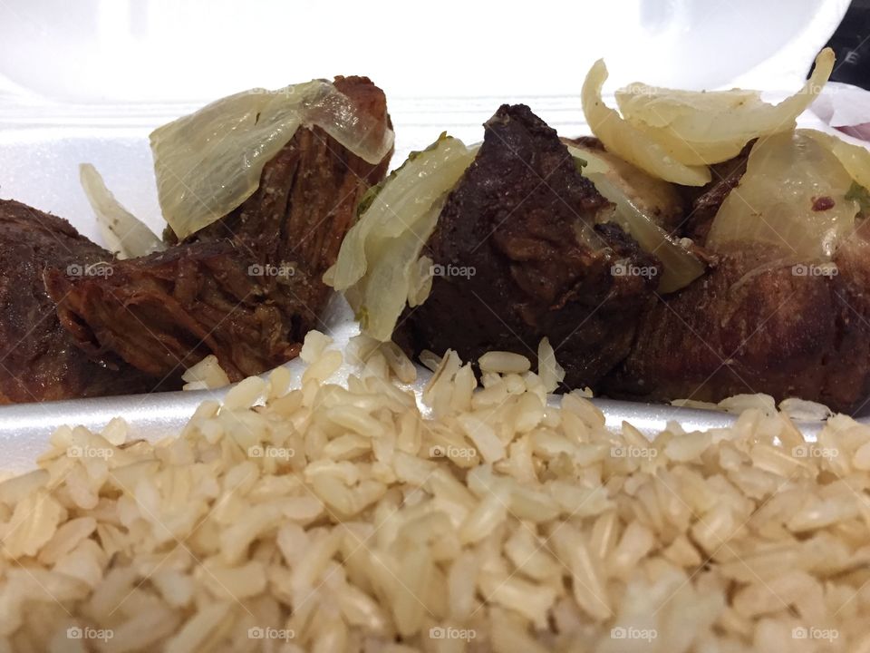 Rice & pork chunks with onions is a topical Cuban food