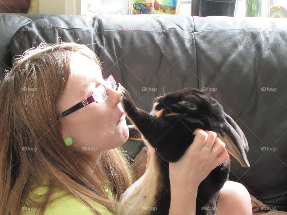 My rabbit lovingly tapping my daughter's nose