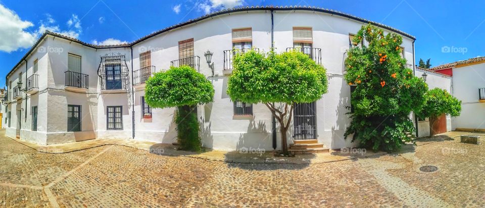 A Panoramic photo of buildings in Ronda Southern Spain. spain, ronda, landmark, landscape, europe, architecture, travel, village, panoramic, andalusia, tourism, nature, view, town, spanish, cliff, sky, city, bridge, building, blue, white, malaga, old