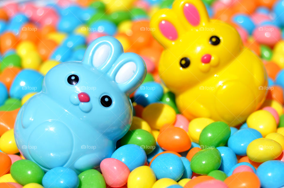 Two Easter Bunnies and colorful candies.