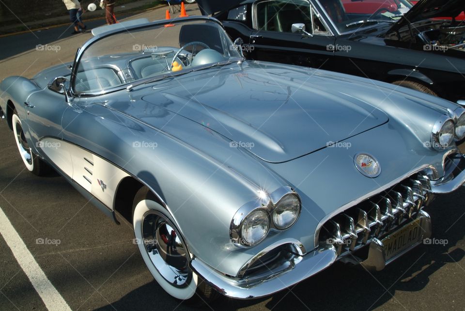 Silver and white stripe 1960 Chevrolet Corvette.