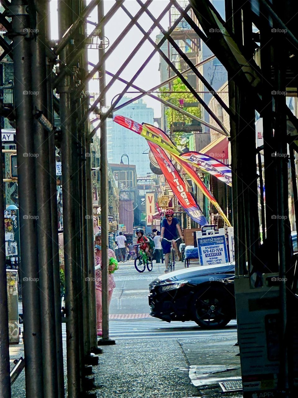 Sometimes a car zooms onto the scene and every molecule flows perfectly beautifully matched in the breeze it creates as seen here walking down “Broadway” in “Bushwick”, Bklyn by the “Myrtle Ave” “M” train station overpass. 2024. Hypnotic Productions