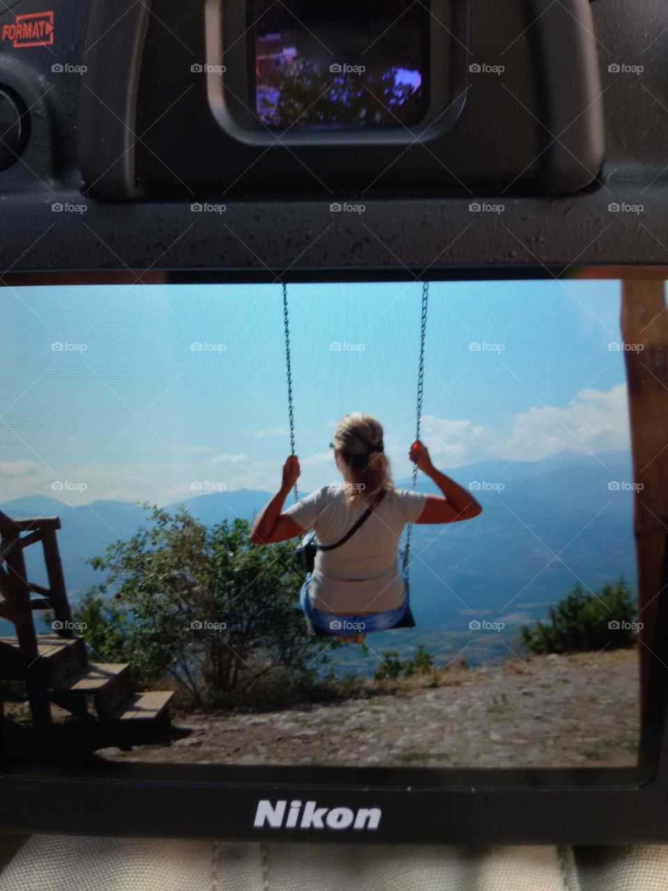 Woman on a swing on mountain