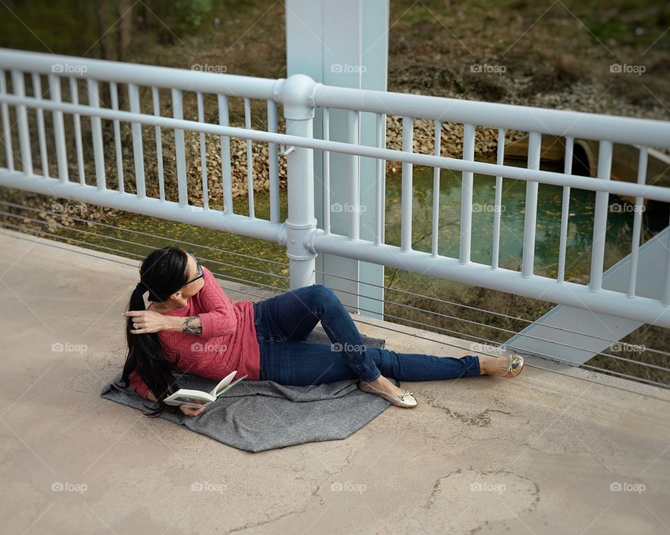 Relaxing comfortably with a good book in the warm sun.