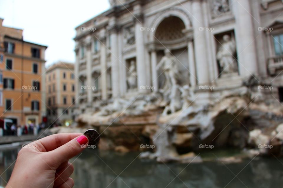Throwing coin at Trevie Fountain