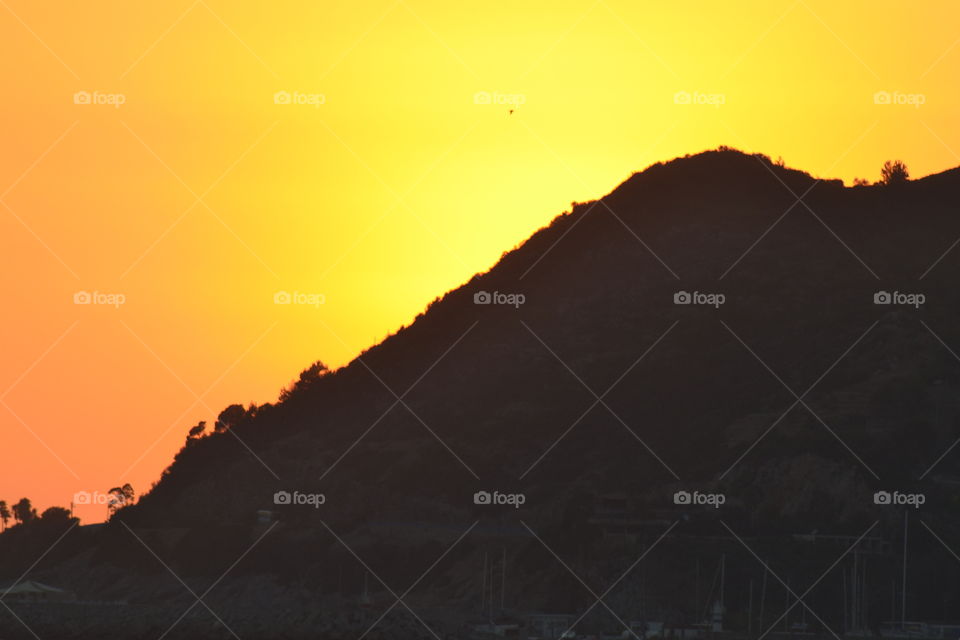 sunsetting behind mountain