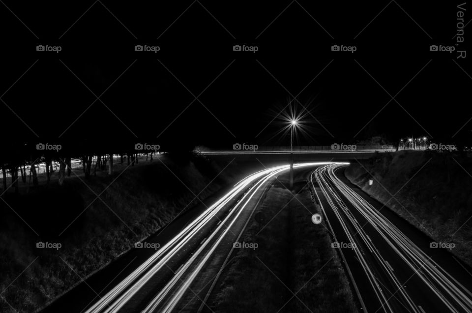 A lot of people, vehicles, light painting the dark background.