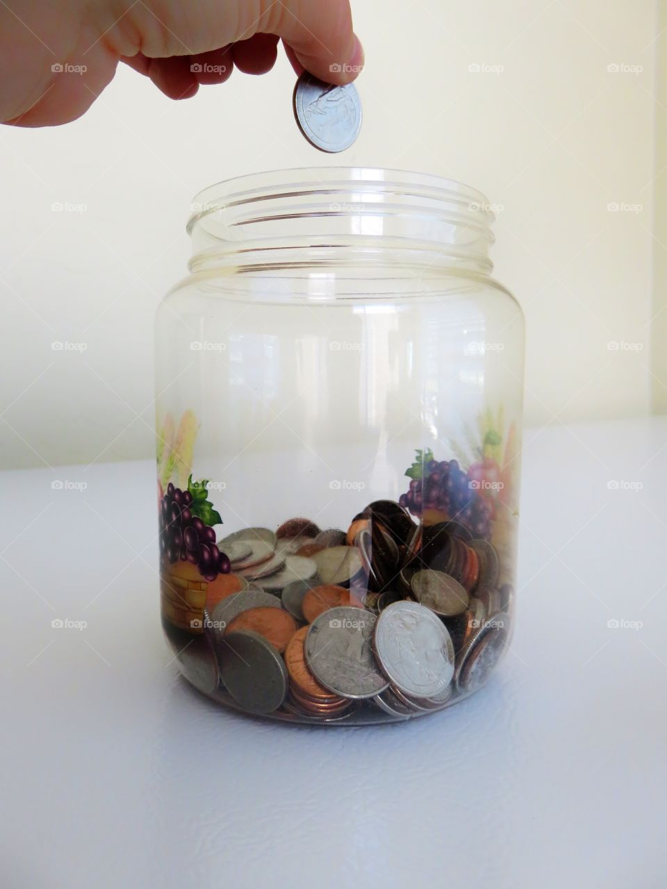 putting coins in a jar