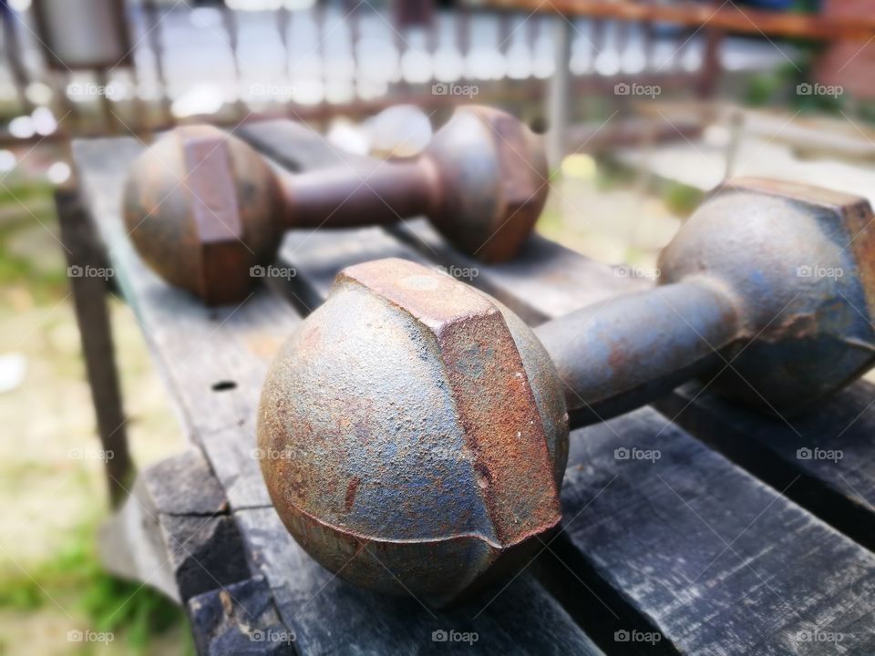 Old dumbbells on wood