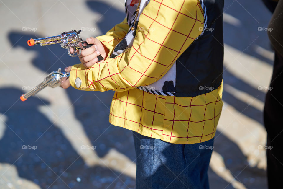 Close-up of cowboy holding guns