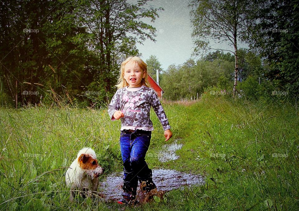 Girl and a dog playing in water