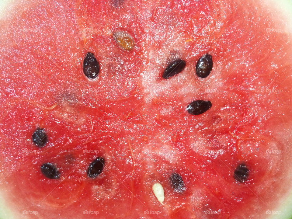 Macro juicy red Watermelon with lots of black seeds