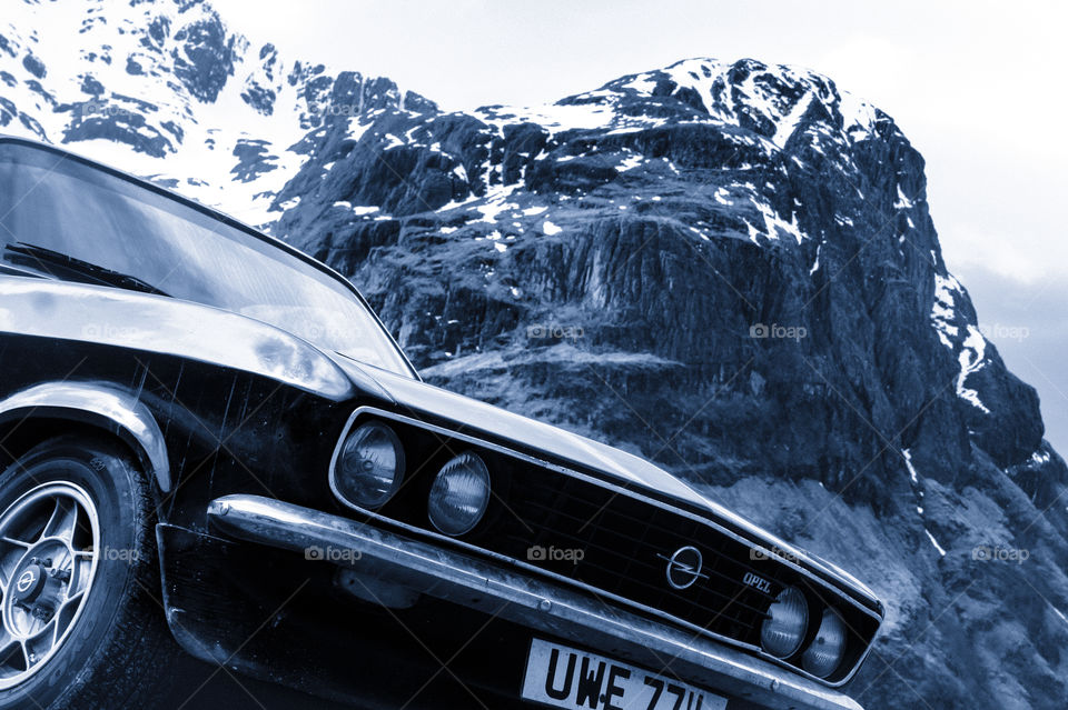 Classic Opel in front off Three Sisters montains Glen Coe.