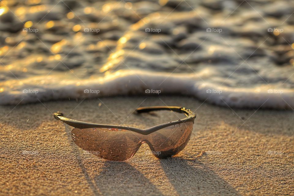 sunglasses in the beach under sand