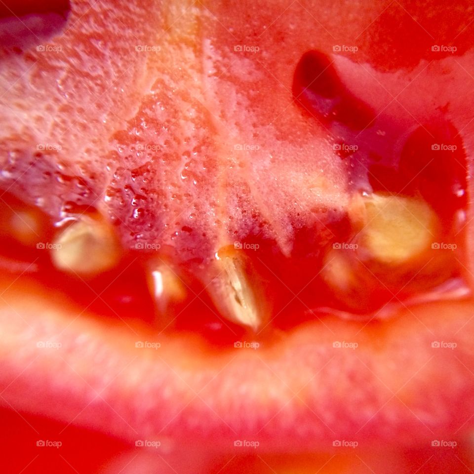 Cutting open a fresh Roma tomato