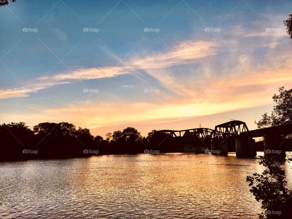 Sunset over an old train bridge 