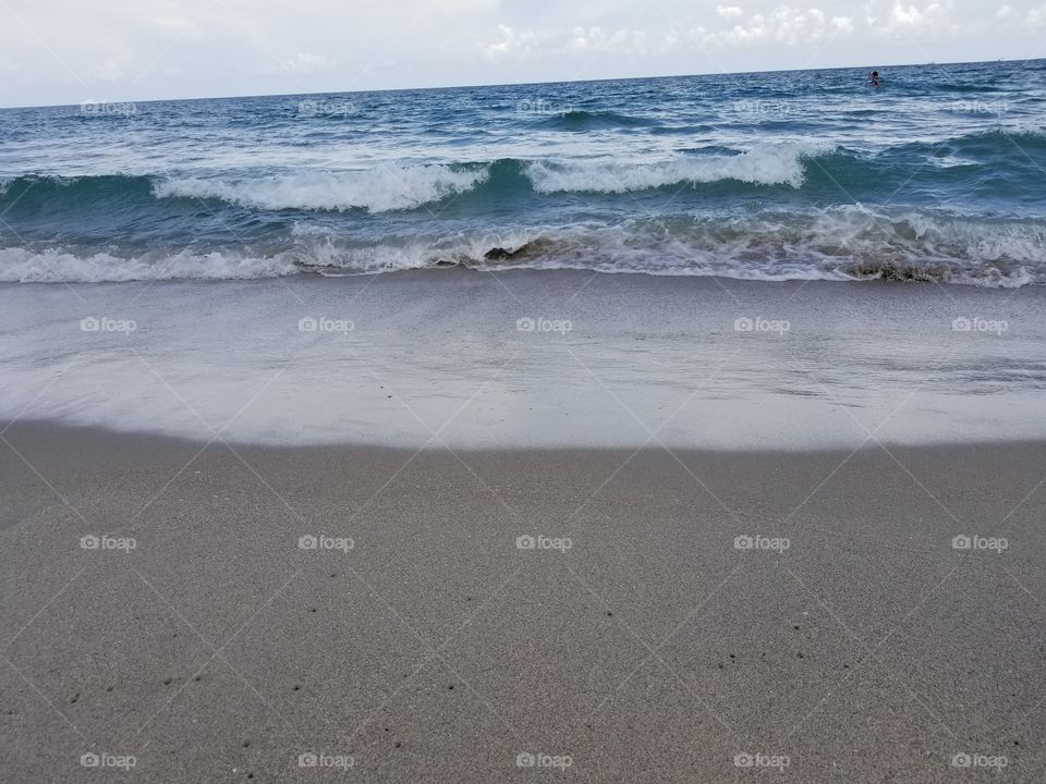 crashing waves on the sand