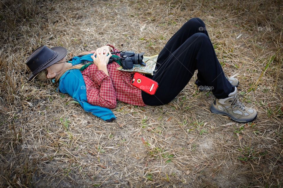 A woman in harmony with nature takes a break after a long hike through the forest.