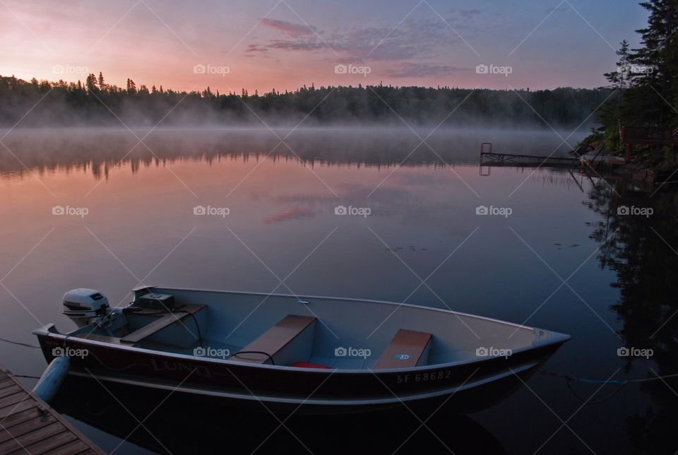 Morning dawn on the lake with fog