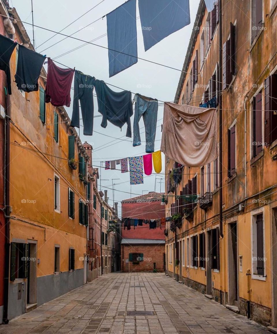 Everyday life in a bustling urban environment, with the clotheslines adding a touch of domesticity to the cityscape