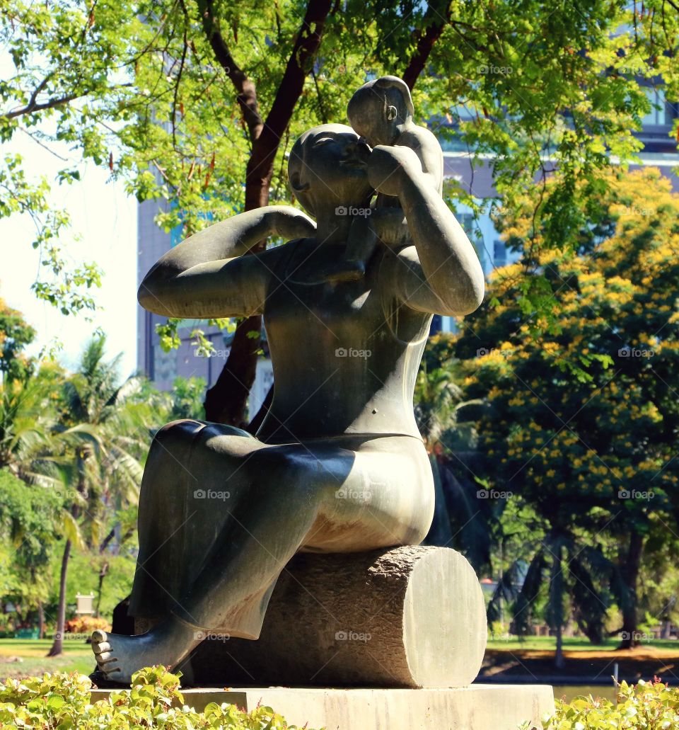 Cool statue at a park in Bangkok. Mother and child.