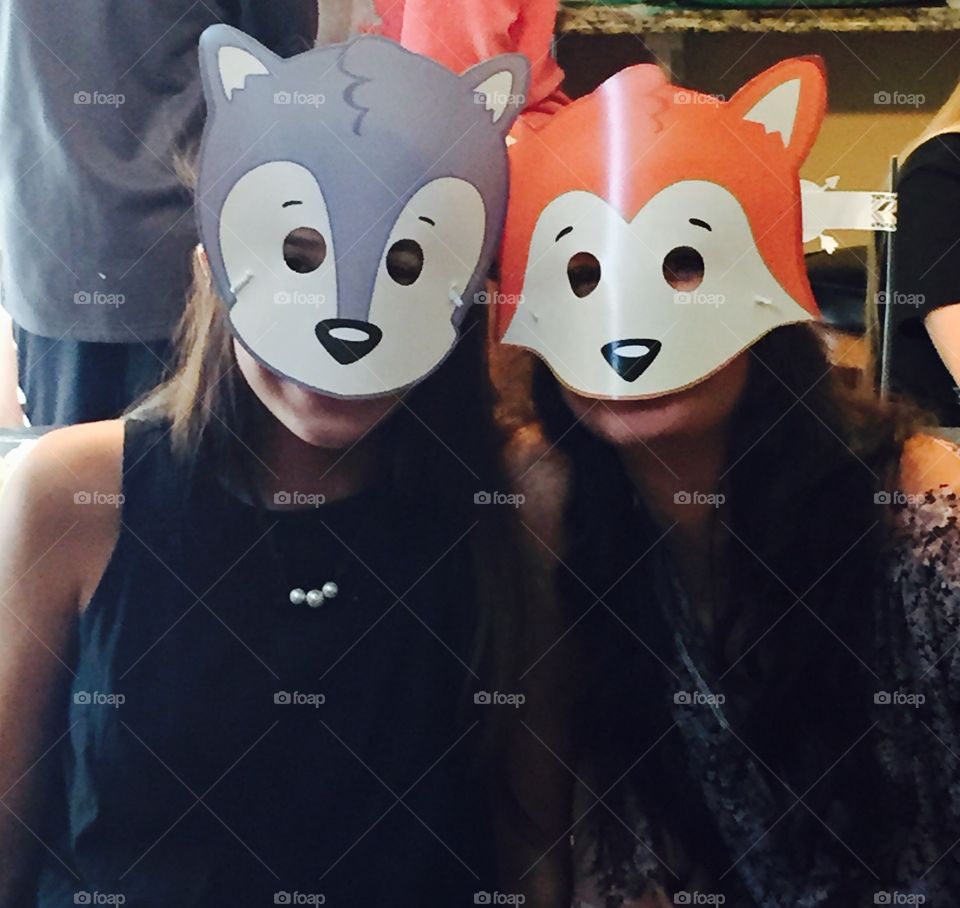 Two ladies in funny masks. 