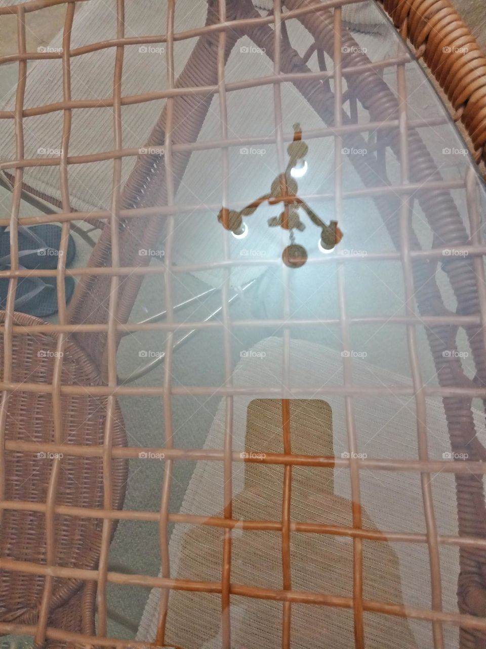 Ceiling lamp reflected on a glass table