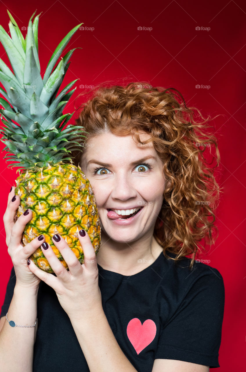 beautiful red-haired girl with pineapple with cool emotions