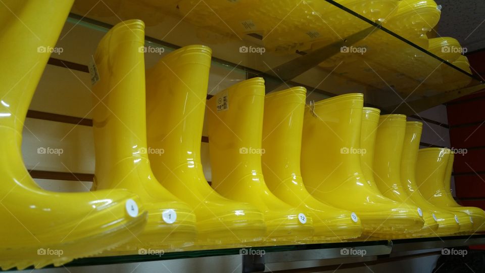 Yellow rain or water boots at a shoe store