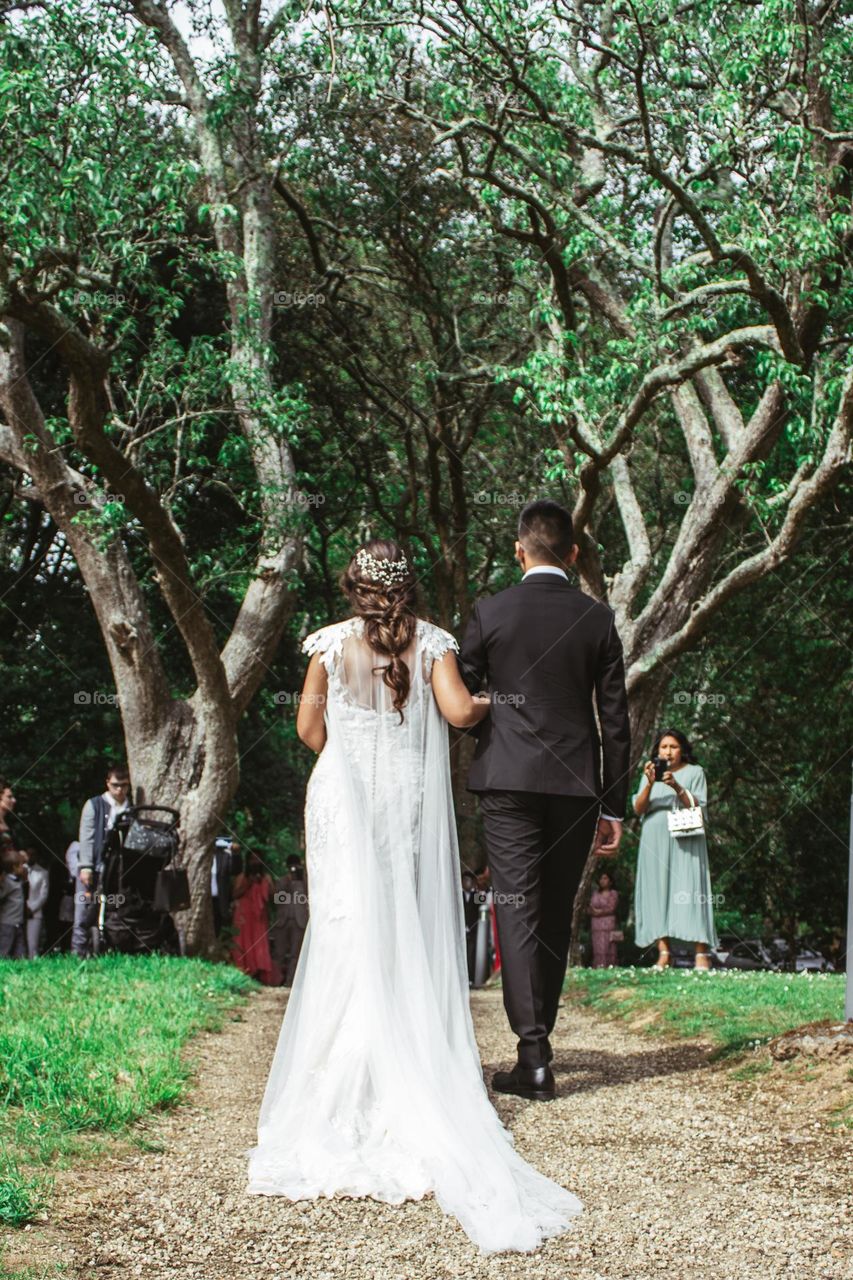 a son walking his mother down the isle