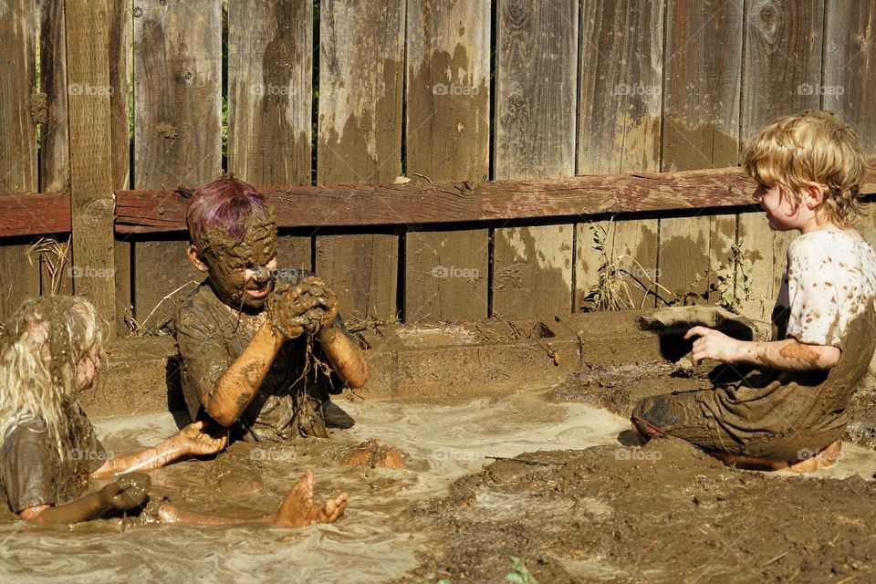 Boys Playing In Mud