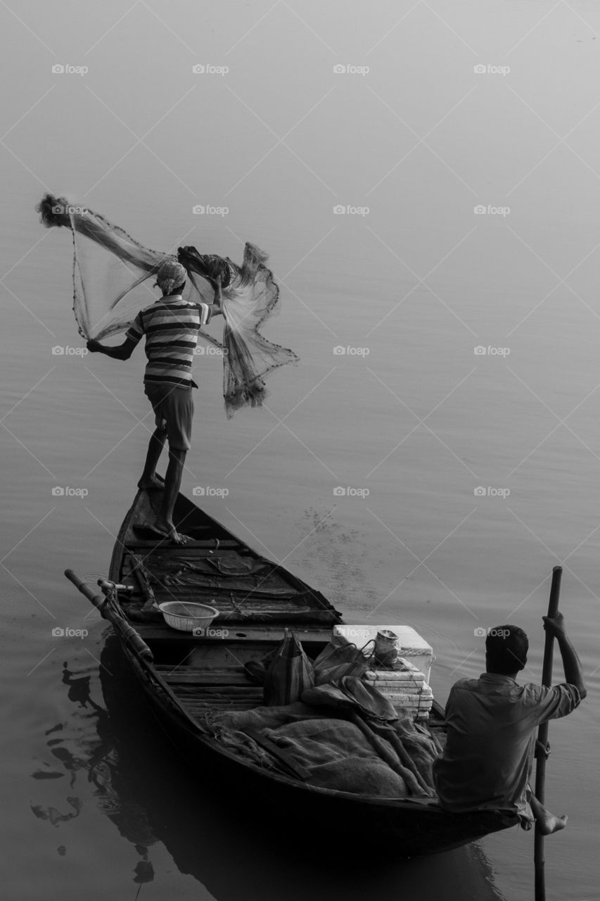 It's the traditional way of fishing using cast net.
