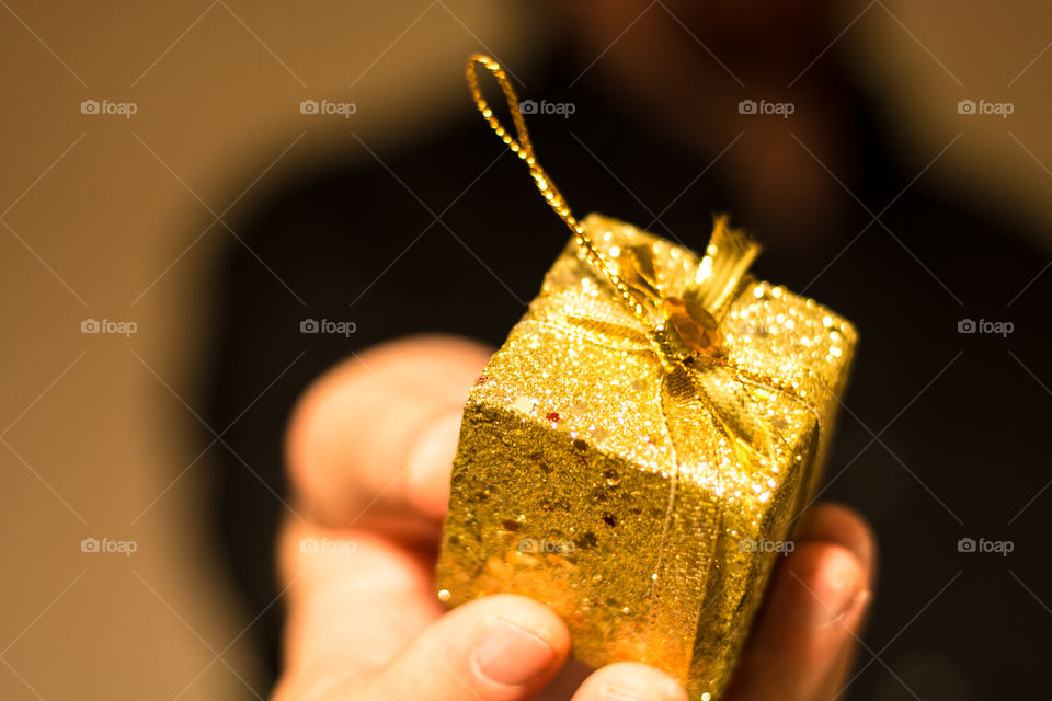 Man Giving Golden Gift
