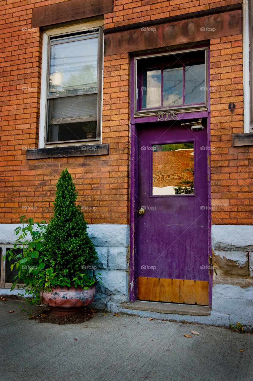 Image of a purple door in a brick building