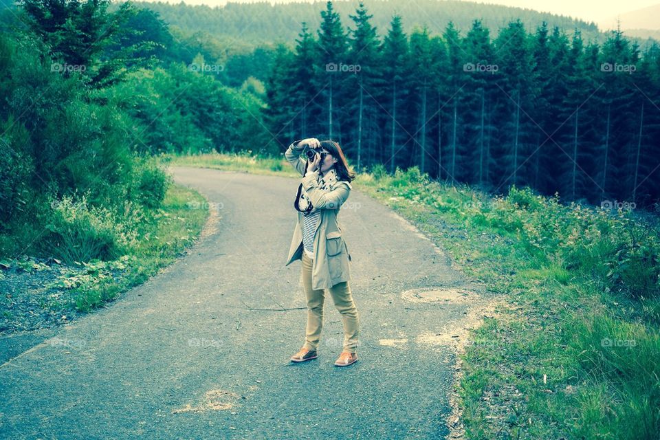 Young woman taking photograph