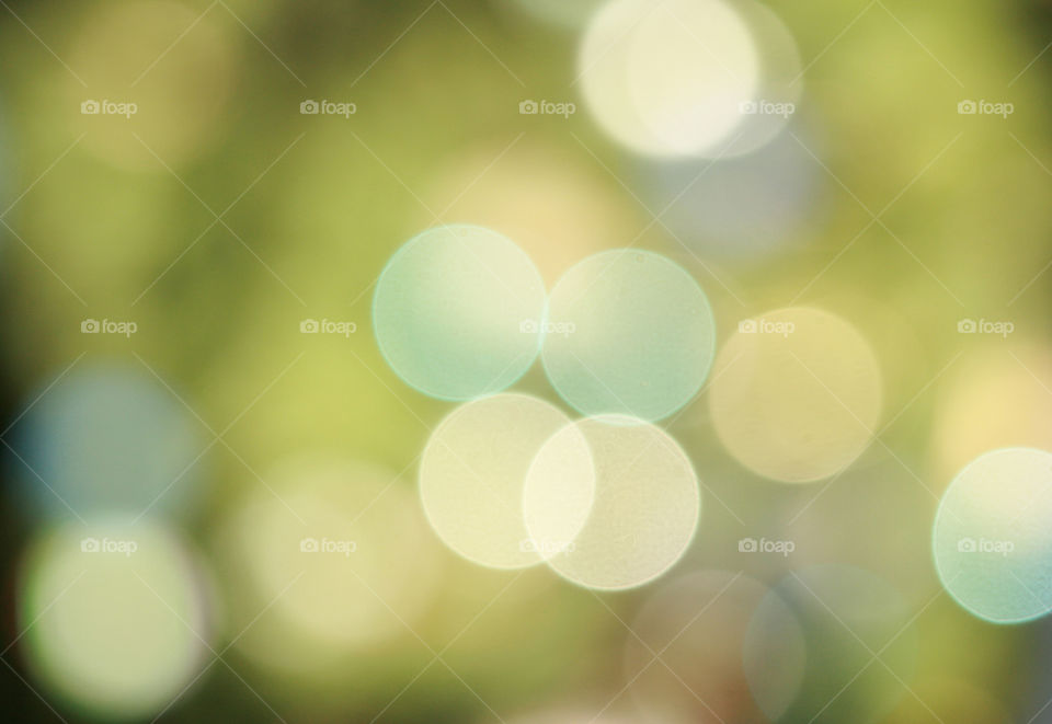 green background with colored lights in the distance