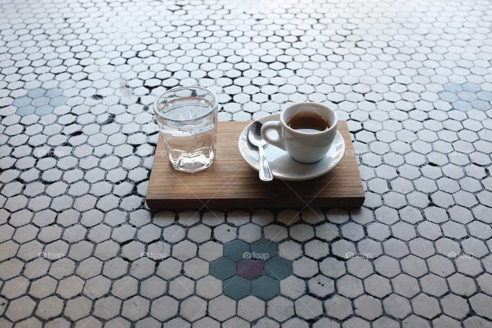 Espresso sitting on the tile. 