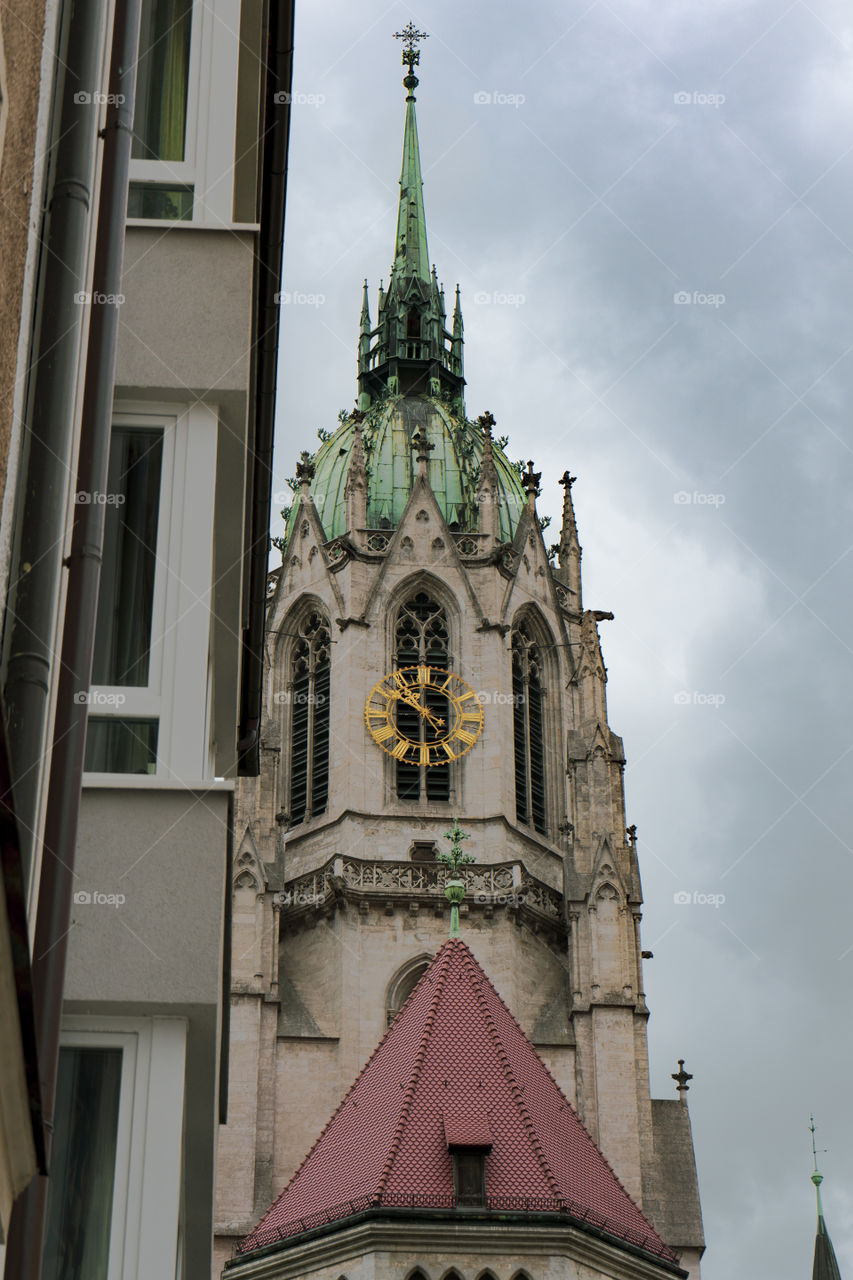 Bell tower of a church in Monaco of Bavaria. Check through the trees.