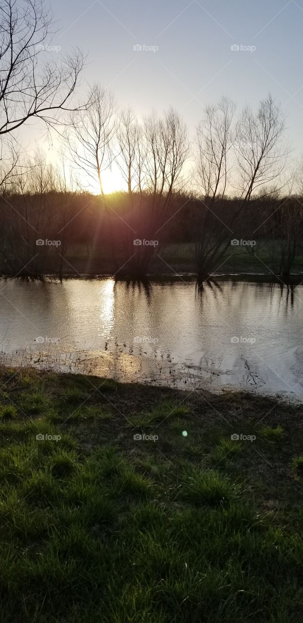 sunset on the pond in the country